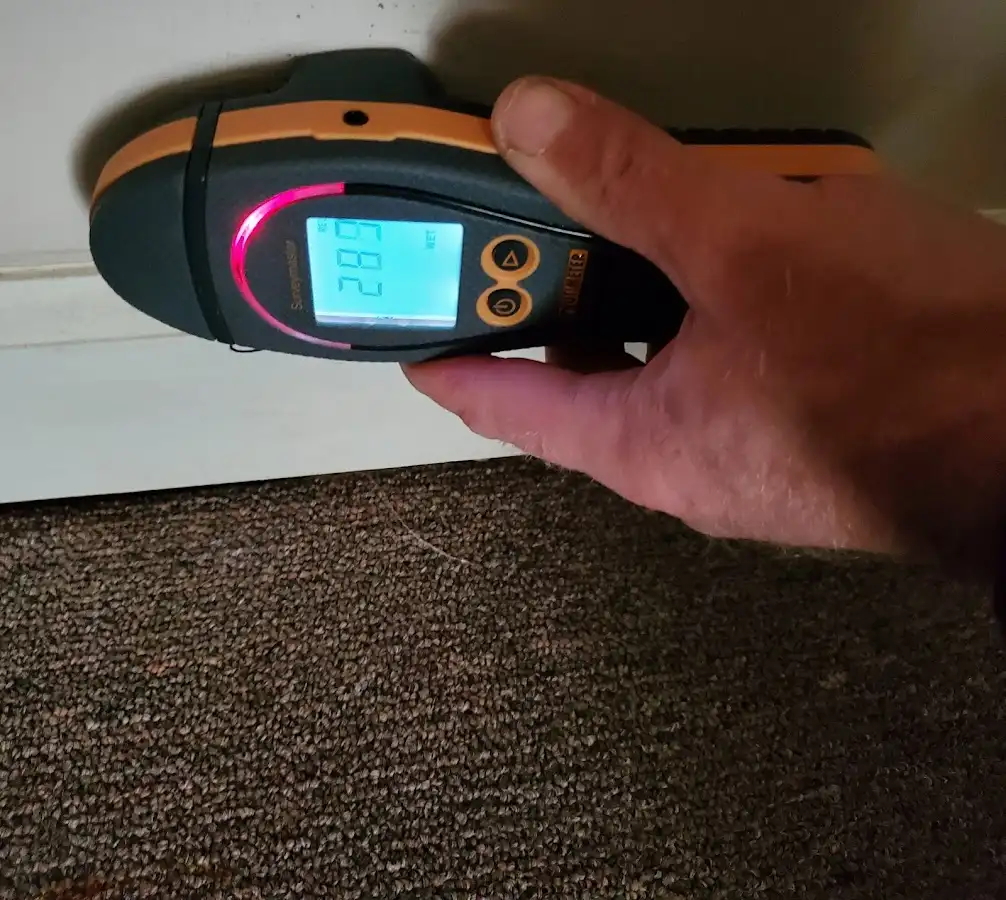 Moisture detection at baseboard during Storm Damage Restoration in Maryville